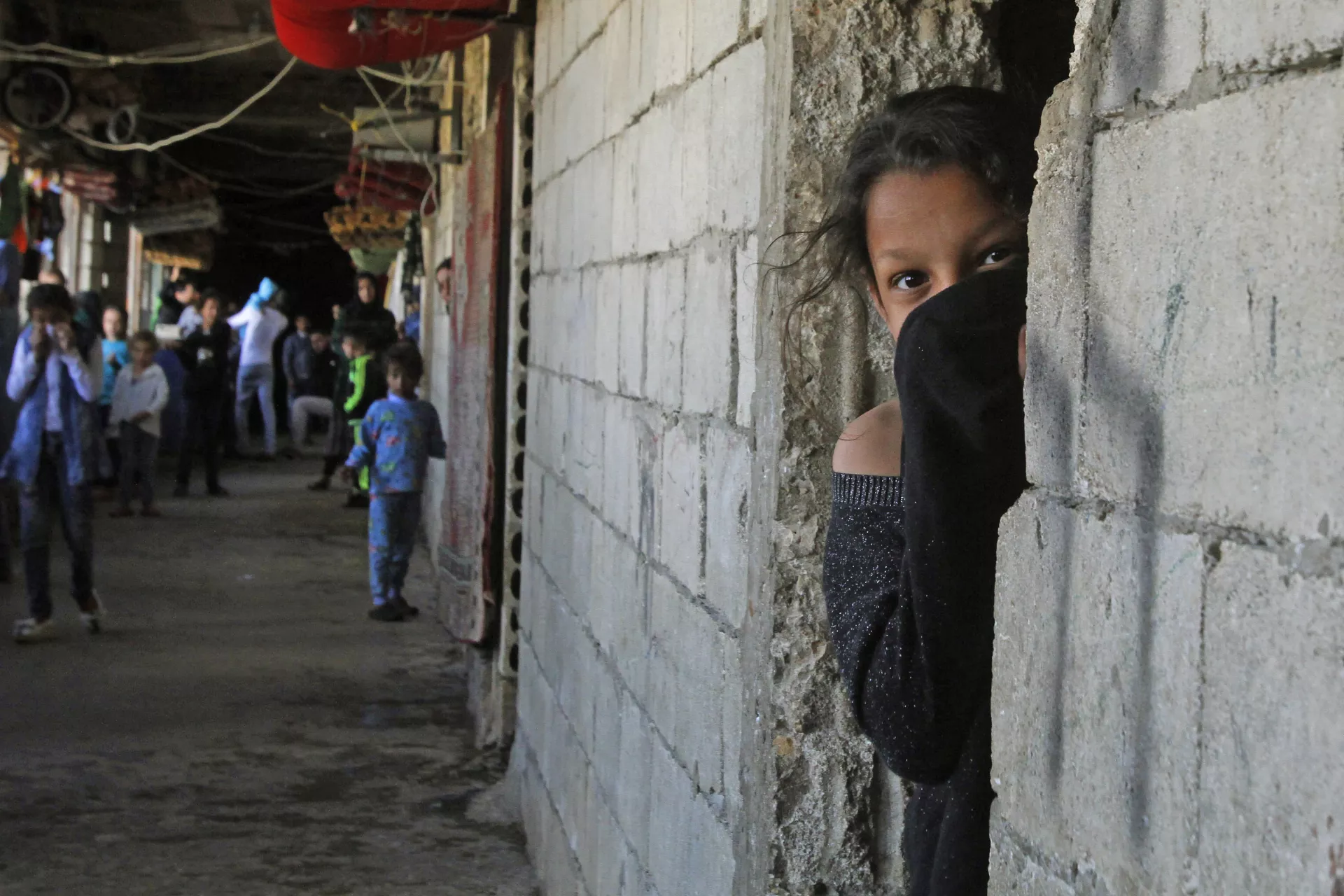 Lebanon. A Syrian refugee looks out of a doorway.