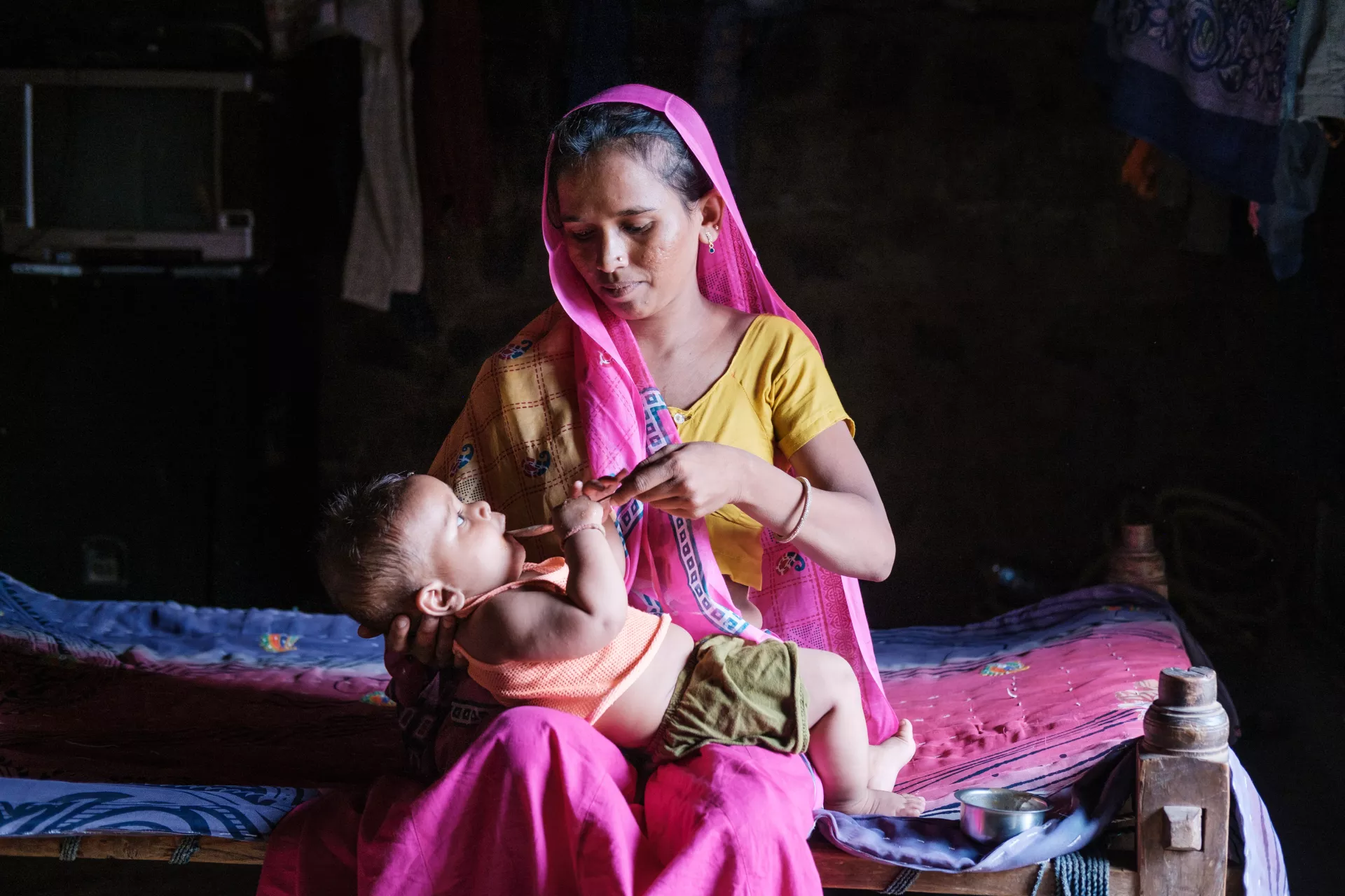 A mother in India feeds her newborn baby.