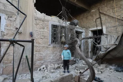 On 16 February 2023, six-year-old Musa stands in the alleyway of his family's damaged house in Jandairis, Syria. 