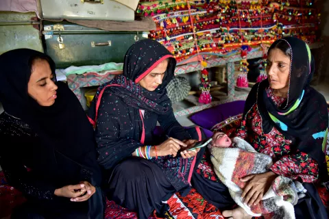 A woman holds a mobile phone, Pakistan