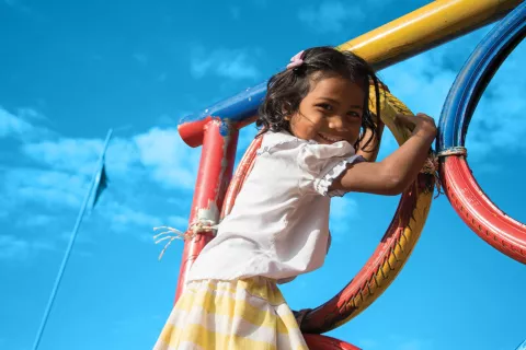 A girl plays in the playground at Srae Tahen primary school, Cambodia