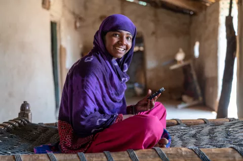 Rekha (17) studies on her phone in Gujarat, India