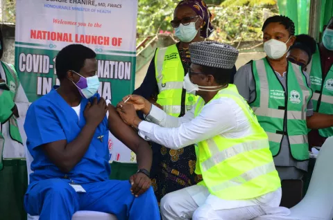 A health workers is vaccinated a doctor how has been working in the isolation centre in Abuja, Nigeria.