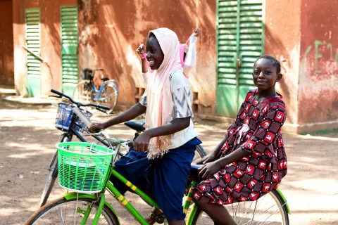 Children ride a bike at their school in Fada, in the East of Burkina Faso.