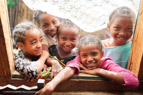 Five young girls smiling towards camera
