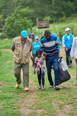 Garry Conille, Regional Director or UNICEF for Latin America and the Caribbean in Panama walking with a migrant family
