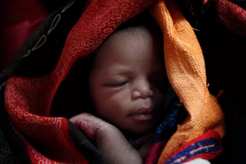 A newborn, wrapped in blankets, sleeps in Wau Hospital in the city of Wau, capital of Western Bahr al Ghazal State in Southern Sudan.