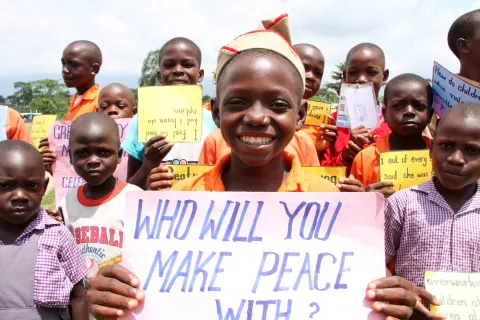 Uganda. Pupils at a school display placards calling for peace.