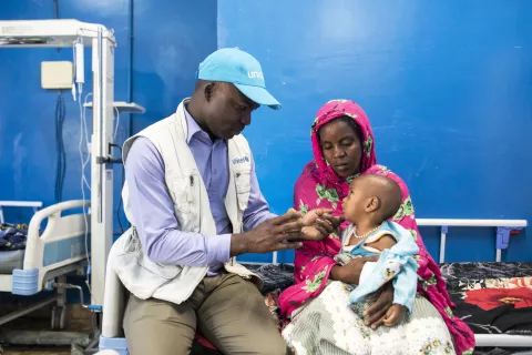 Mali. A health specialist checks on a child.