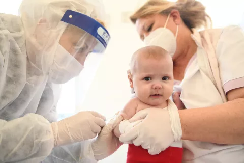 Nurses in Kosovo immunizing children when vaccination programme was resumed, COVID-19