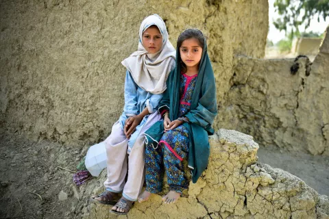Muriko bibi (7) and Tehseen (6) sit on the damaged wall of their mud house which was almost destroyed during the 2022 floods in Pakistan.  They belong to village Chitool, Rajanpur district of South Punjab province, Pakistan. The flood water completely inundated their village and they were forced to live on the embankment of a damaged road for weeks before moving back to their village where almost every house was damaged or destroyed. One of the major problems the community faced was not having clean drinkin