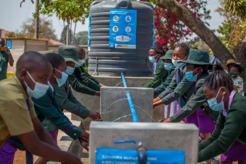Zimbabwe. Children wash their hands outside.
