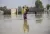 Pakistan. A woman holds her daughter as she stands in floodwaters in Sindh Province, Pakistan.