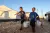 On 24 September 2019 in Idlib in the Syrian Arab Republic, children carry water containers from a tanker to take into the displaced camp near the town of Taftanaz.