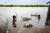 Two young boys playing in the banks of the Mekong river, Cambodia.