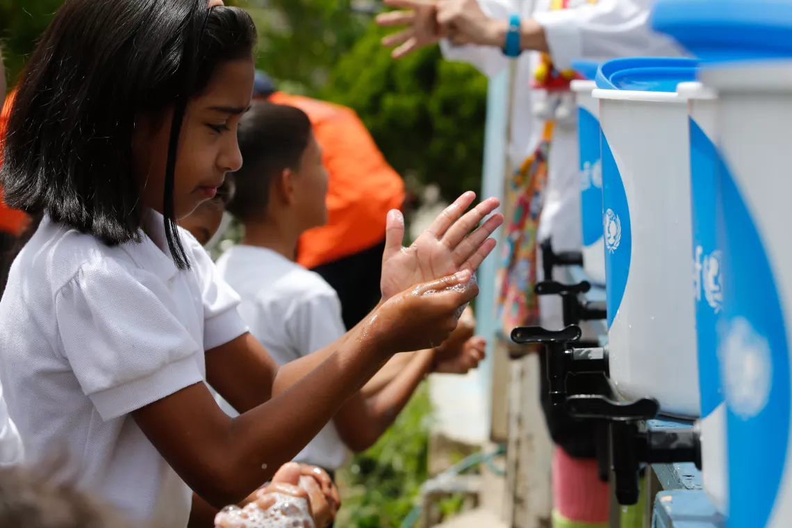 Venezuela. Children learn how to wash their hands properly with soap and water during an activity supported by UNICEF in a school located on the outskirts of Caracas. 