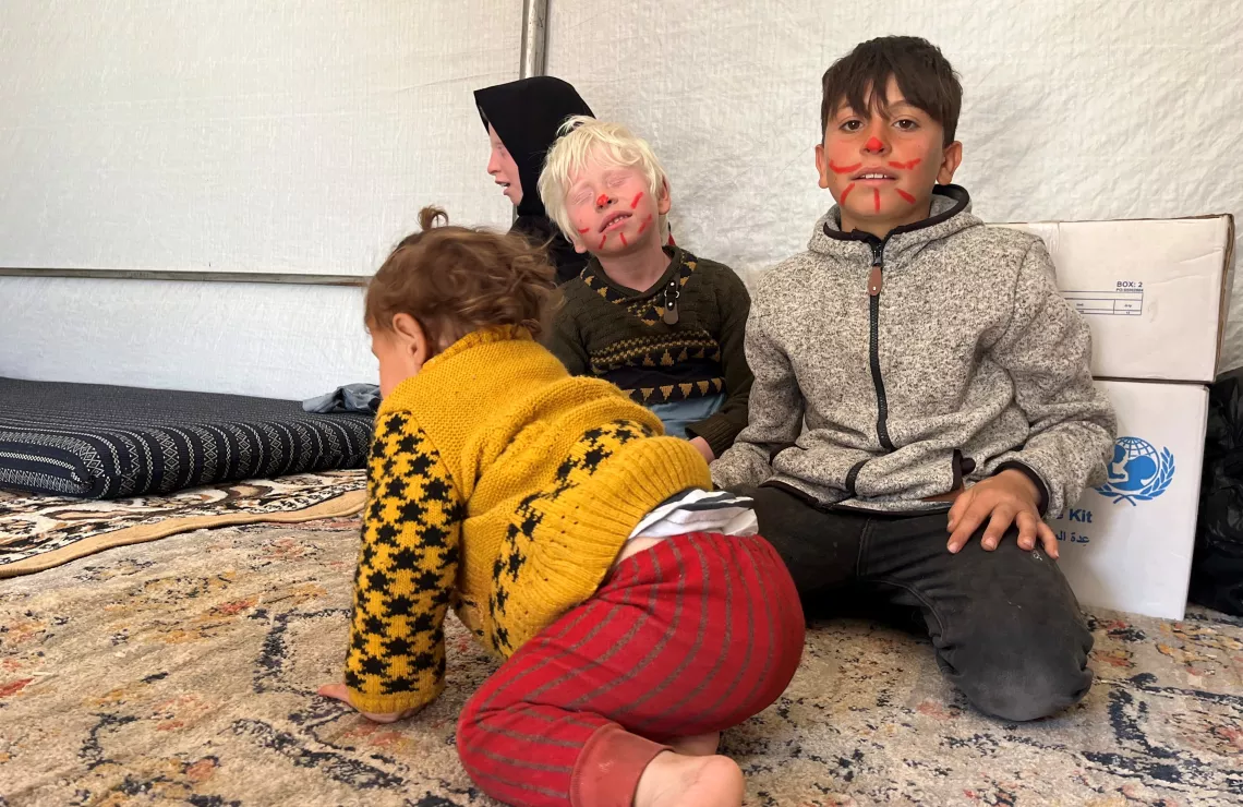 Syria. Abdul-Karim, right, sits with some of his siblings after they return from an activity session at the camp organized for people displaced by the earthquakes.
