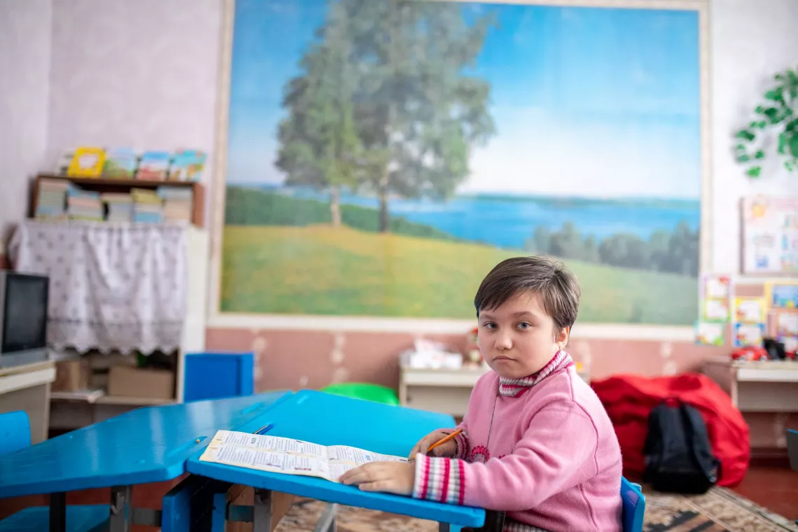 Ukraine. A child sits in a classroom.
