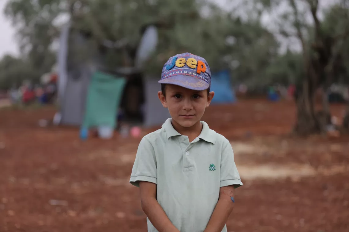 Syria. A boy stands near a makeshift shelter.