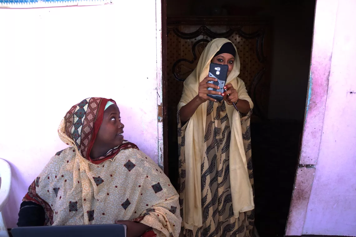 A woman takes a photo with a mobile phone, Djibouti