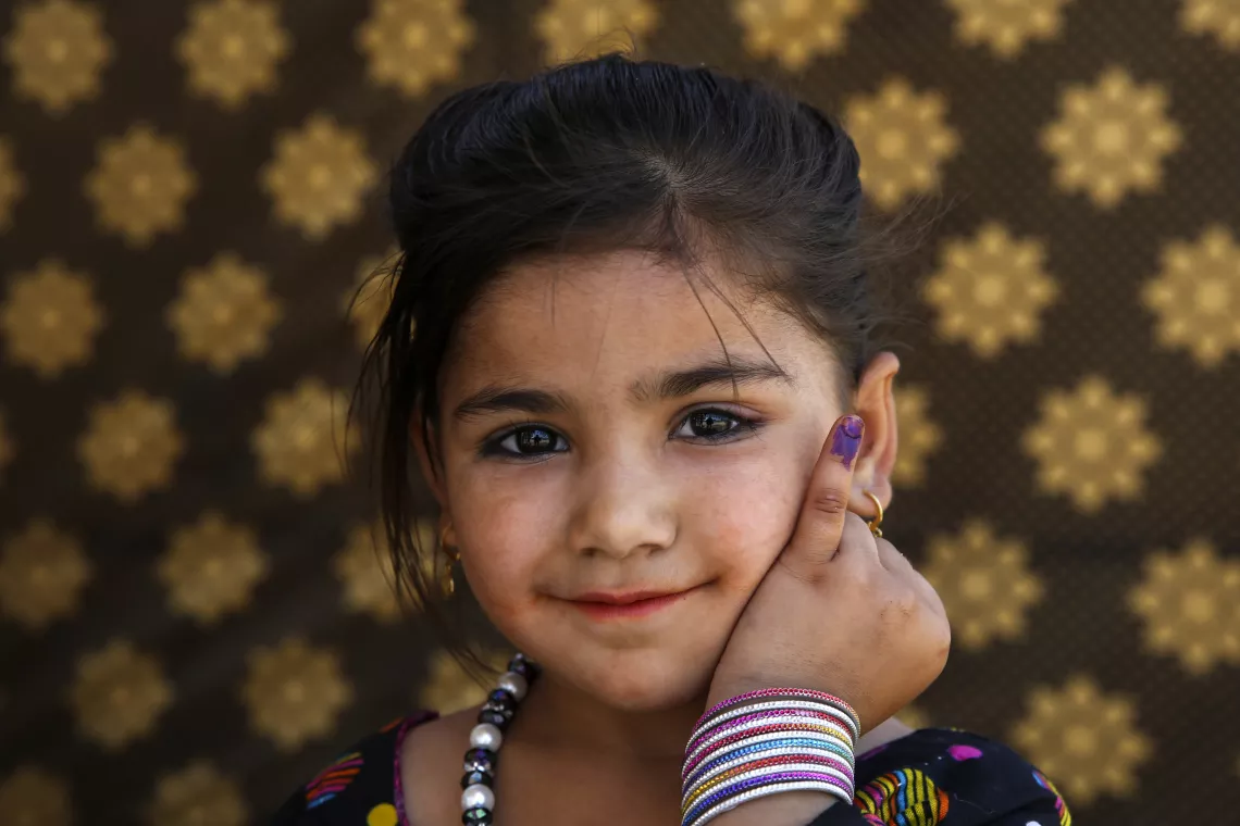 In Islamabad, Pakistan, Mariya, 5, shows the ink mark on her little finger which confirms that she has received a polio vaccine during a Polio National Immunization Day.