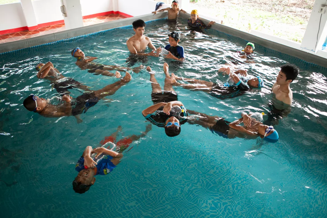 Swimming teachers at Huayprayai Padungvitaya School in Thailand teach students that they can use empty bottle to help them float in the water to prevent drowning.
