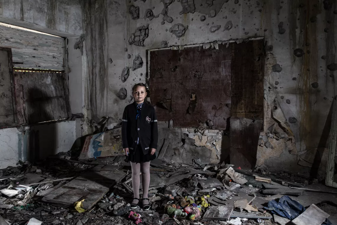 A child in a destroyed classroom in eastern Ukraine.