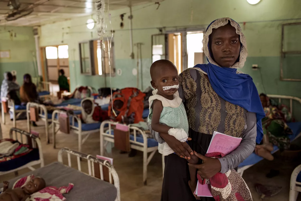 A woman holds a child at Friendship Hospital in N'Djamena, Chad.