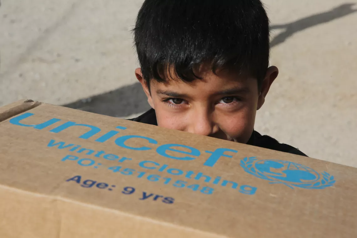 Lebanon. A Syrian refugee holds a box of supplies.