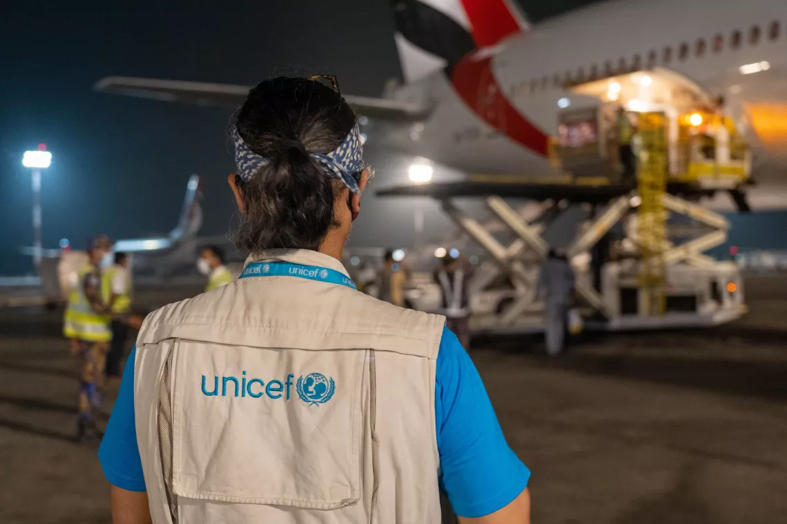 A UNICEF worker stands on the airport's tarmac as the first COVAX doses landed in Bangladesh.