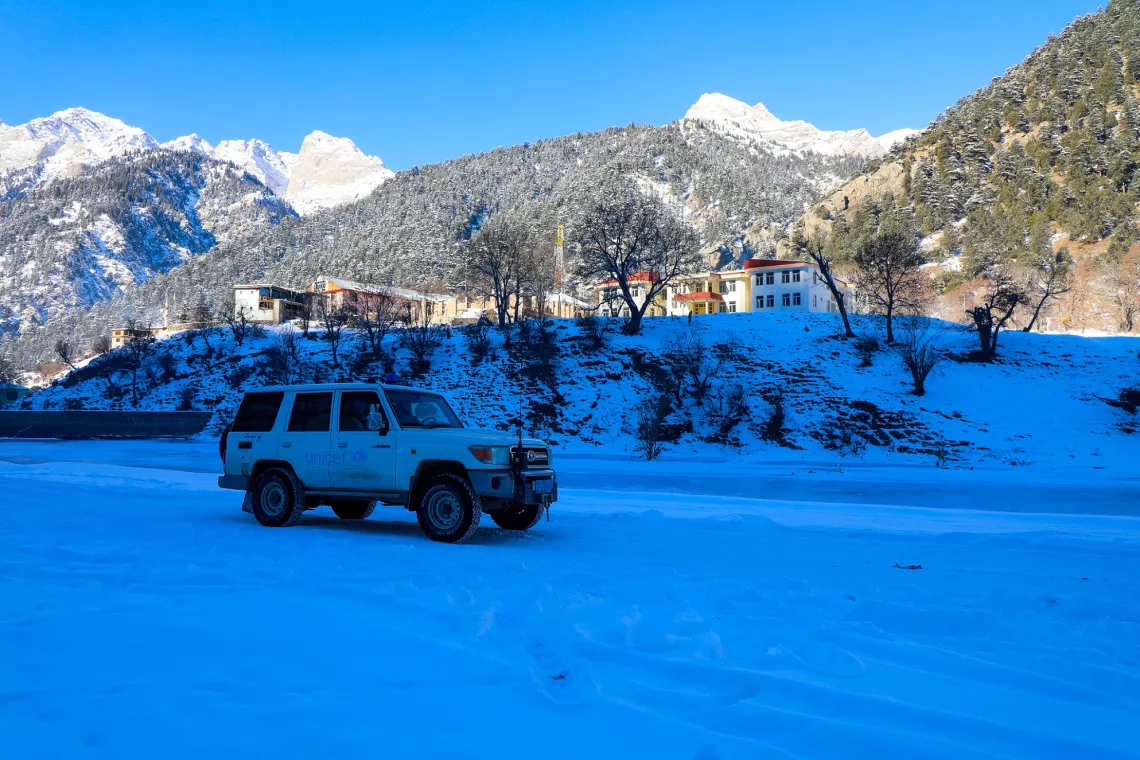 Afghanistan. A UNICEF vehicle drives across snow in Nuristan Province.