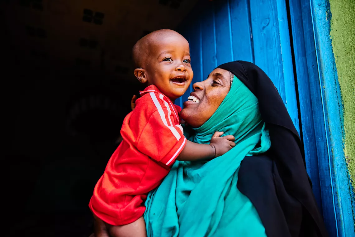 Kaha Hassan plays with her one-year-old son Sudeys in Garissa county, Kenya.