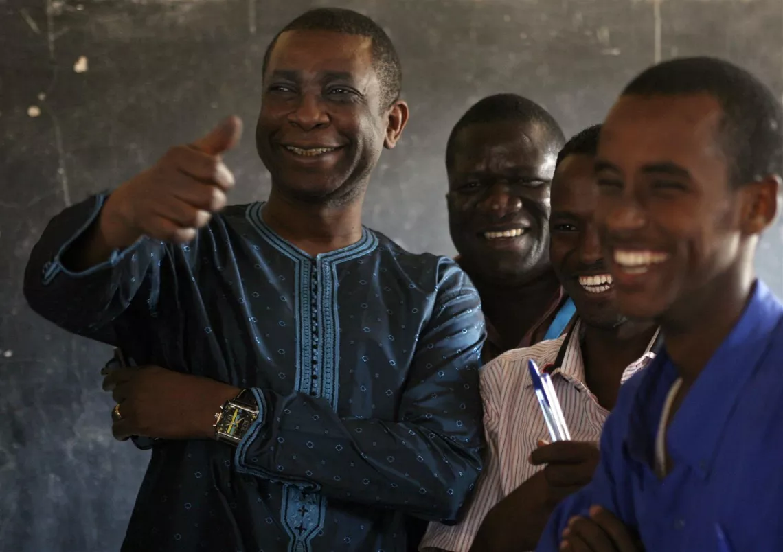 On 5 September, UNICEF Goodwill Ambassador Youssou N’Dour (left) smiles and makes a thumbs-up gesture while meeting students at a school in the Dagahaley refugee camp, in the north-eastern town of Dadaab, Kenya.