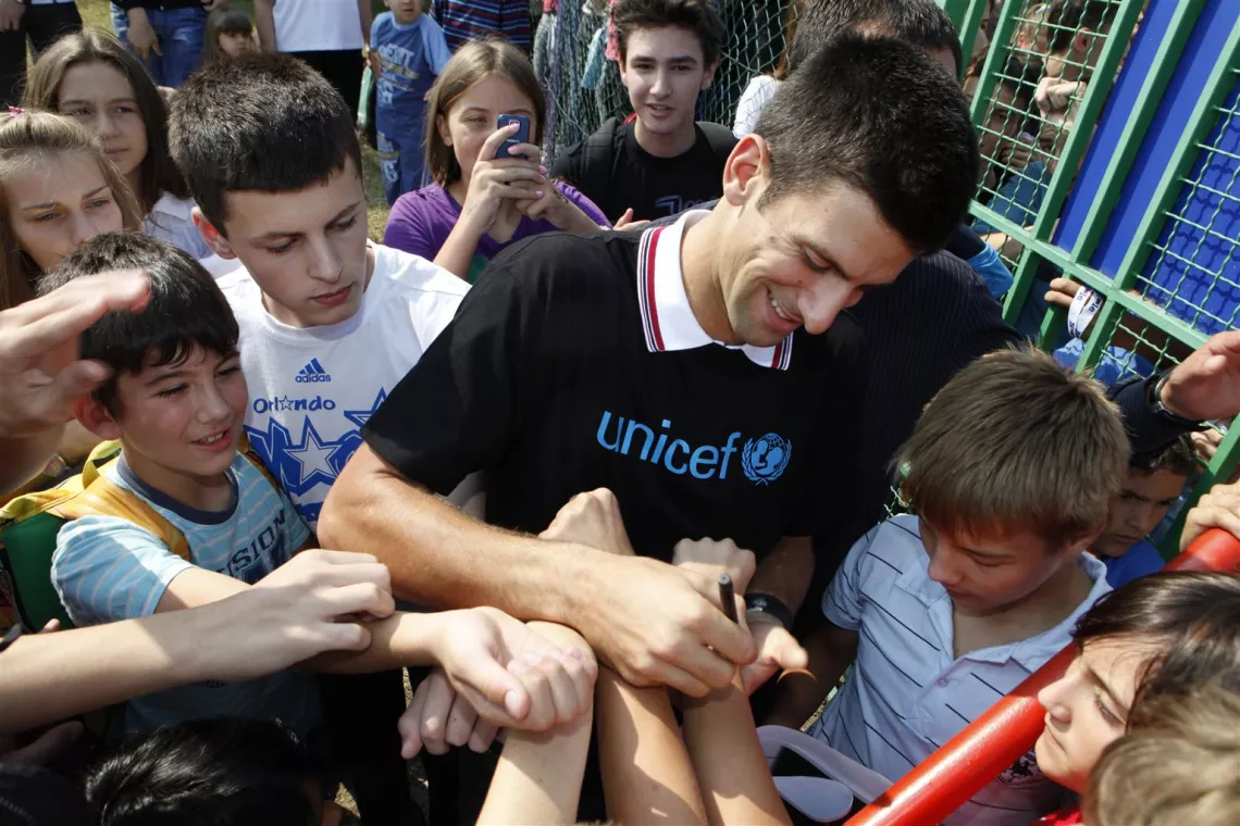 UNICEF National Ambassador for Serbia Novak Djokovic autographs children’s outstretched hands during his visit to Pcelica (‘Little Bee’) Nursery School in the town of Smederevo, near Belgrade, Serbia.