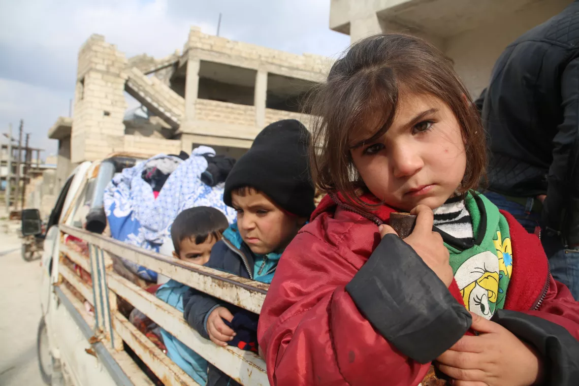 Syria. Children sit in the back of a truck.