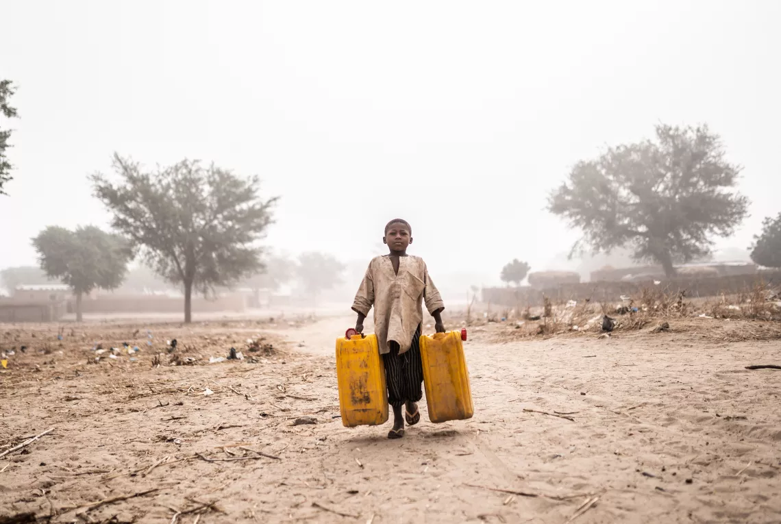 Early in the morning, children go to fetch water at the nearest water point, 15 kilometres away from their home in Tchadi village.
