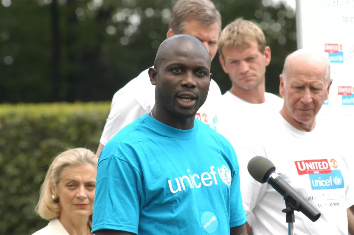 UNICEF Goodwill Ambassador and internationally known Liberian football player George Weah (wearing a blue UNICEF T-shirt) addresses the audience at the 'United for UNICEF' event on the North Lawn at UNHQ.