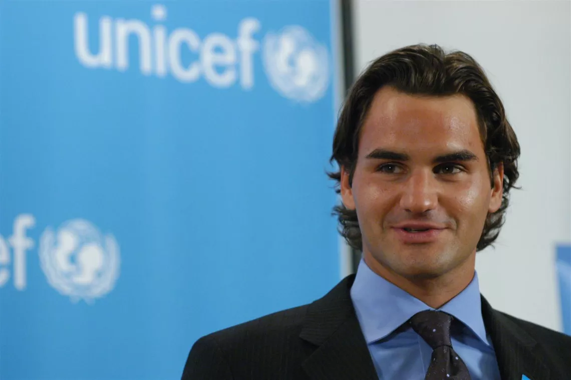 Roger Federer accepts his appointment as a UNICEF Goodwill Ambassador at UNICEF House on 3 April 2006. Behind him, the UNICEF logo can be seen.