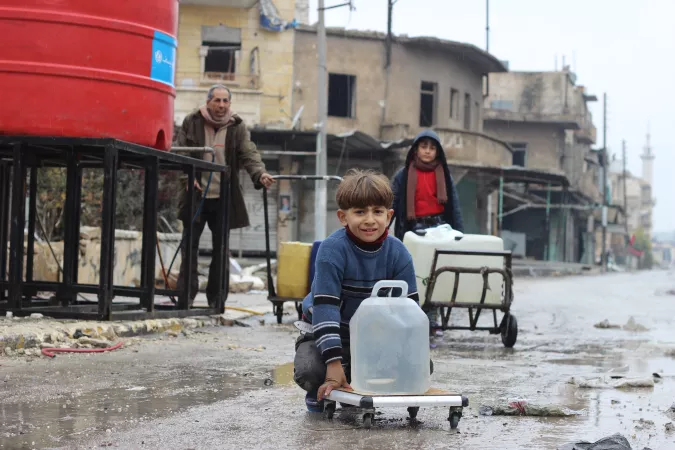Families collect water from a UNICEF-supported water point in Shakoor neighbourhood, in east Aleppo City in the Syrian Arab Republic. 