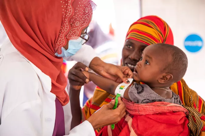 Ethiopia. A health worker measures the arm of a child to assess his nutrition status.