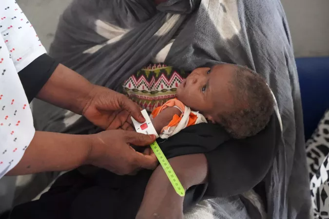 8-months-old boy is screened for malnutrition by a nutritionist.