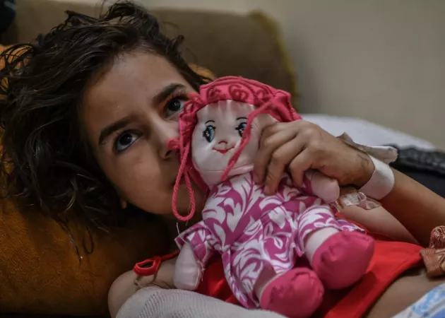 Gaza. A girl holds a doll at her home in Gaza City.