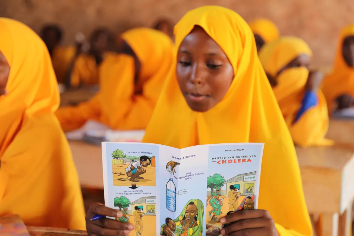 A pupil reading a cholera pamphlet.