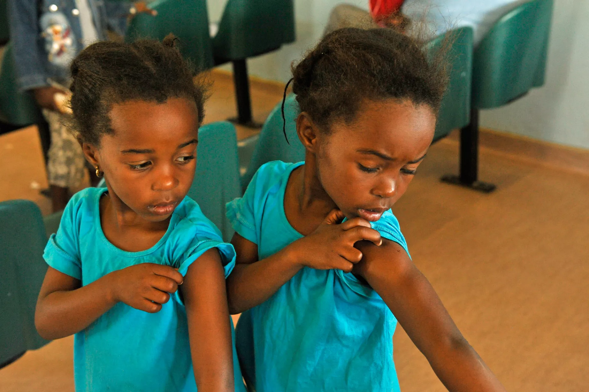 sisters-looking-at-vaccination-on-their-arms