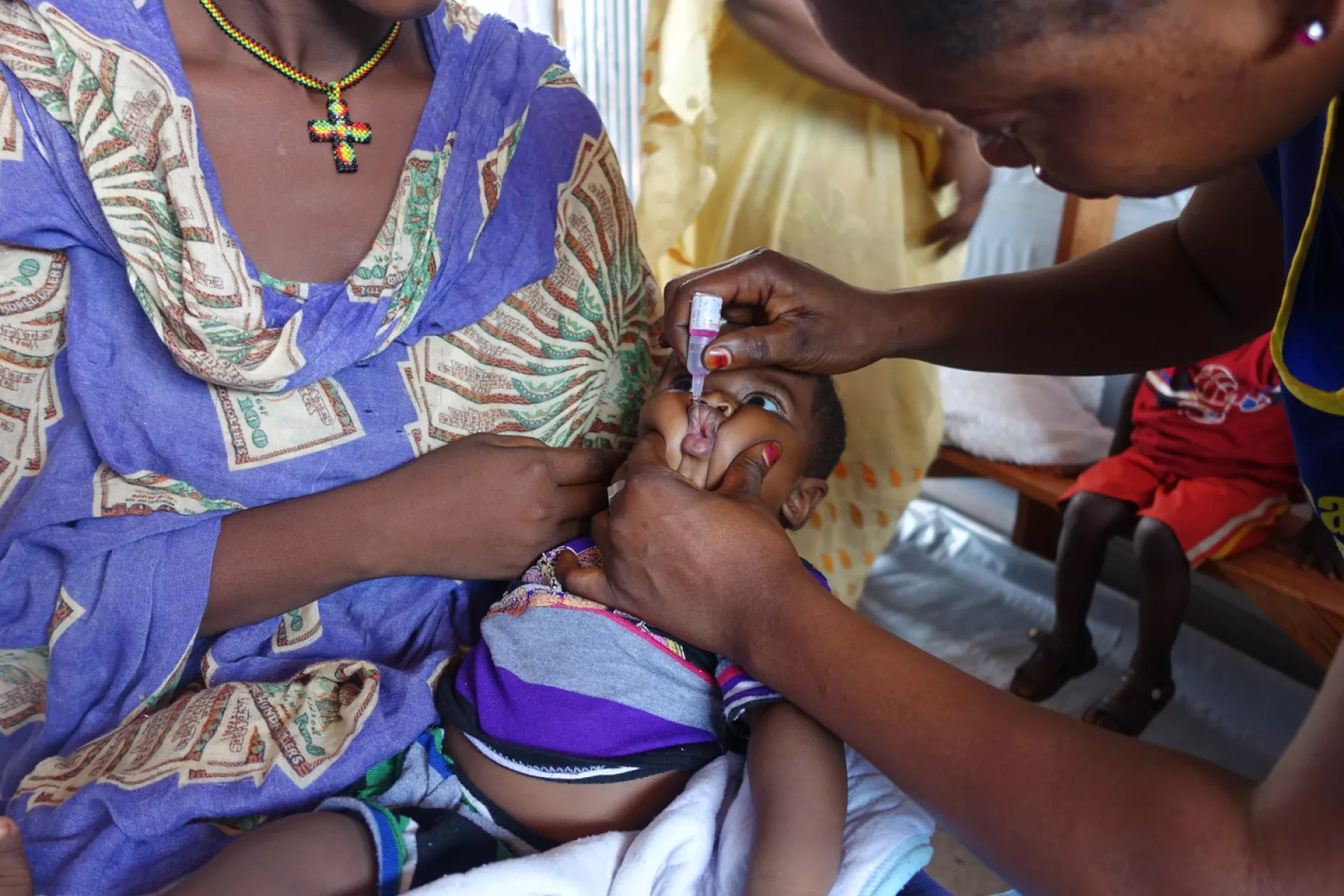 Sabir, 5 months, is administered an oral poliovirus vaccine