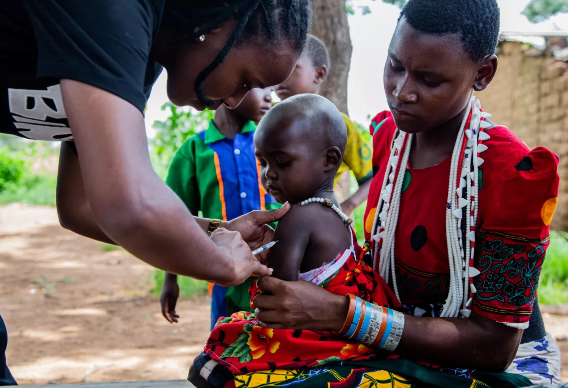 Prisca Mkungwa administers the measles-rubella vaccine during an outreach for integrated services at Masiano sub-village, Chunya district, Mbeya Region.
