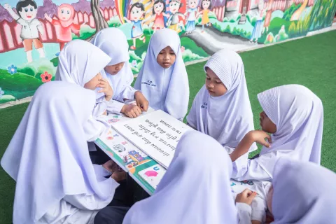 Young students at Than To district of Yala Province read books provided by UNICEF-supported Mobile Library which aims to improve literacy among children living in the deep south.