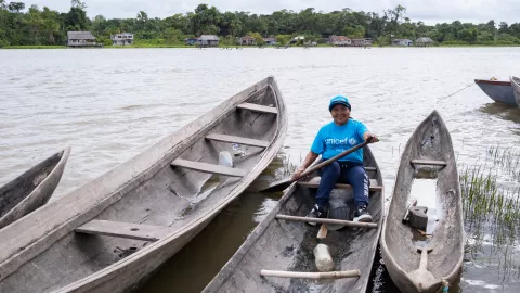 María Torres, a consultant with the indigenous community of Warao, smiles for the camera on board a curiara (artisanal boat) in the Orinoco River in San Francisco de Guayo on the Delta Amacuro State on 21 March 2023.