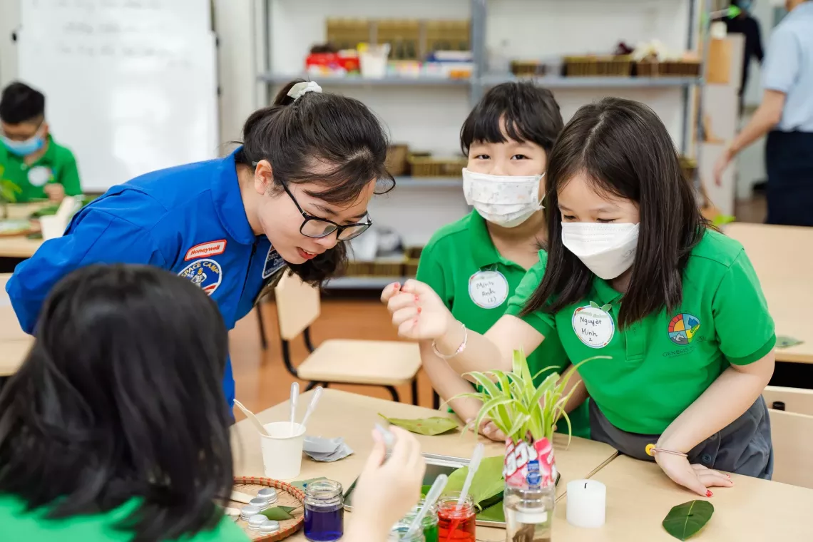 Quyen and school girls are trying out new planting method