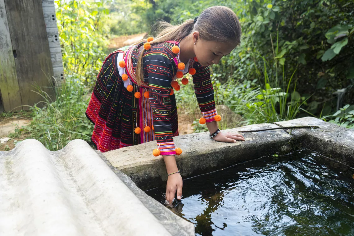 Hang Nisa, 10, shows the old well, from where her teachers had to fetch water every morning in early 2015. UNICEF and partners have been supporting many schools in Dien Bien including Pu Nhi elementary school, to ensure children have access to safer water and better sanitation facilities since 2019.
